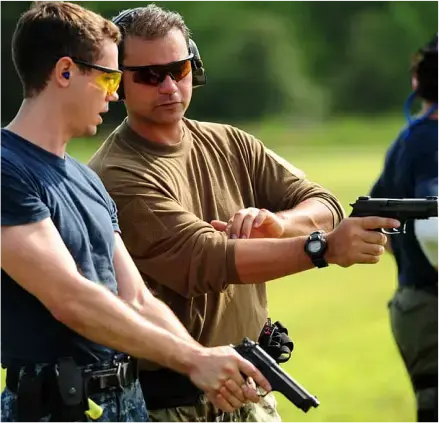 Firearms instructor teaching concealed carry permit class students.