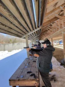 People practicing shooting at outdoor range.