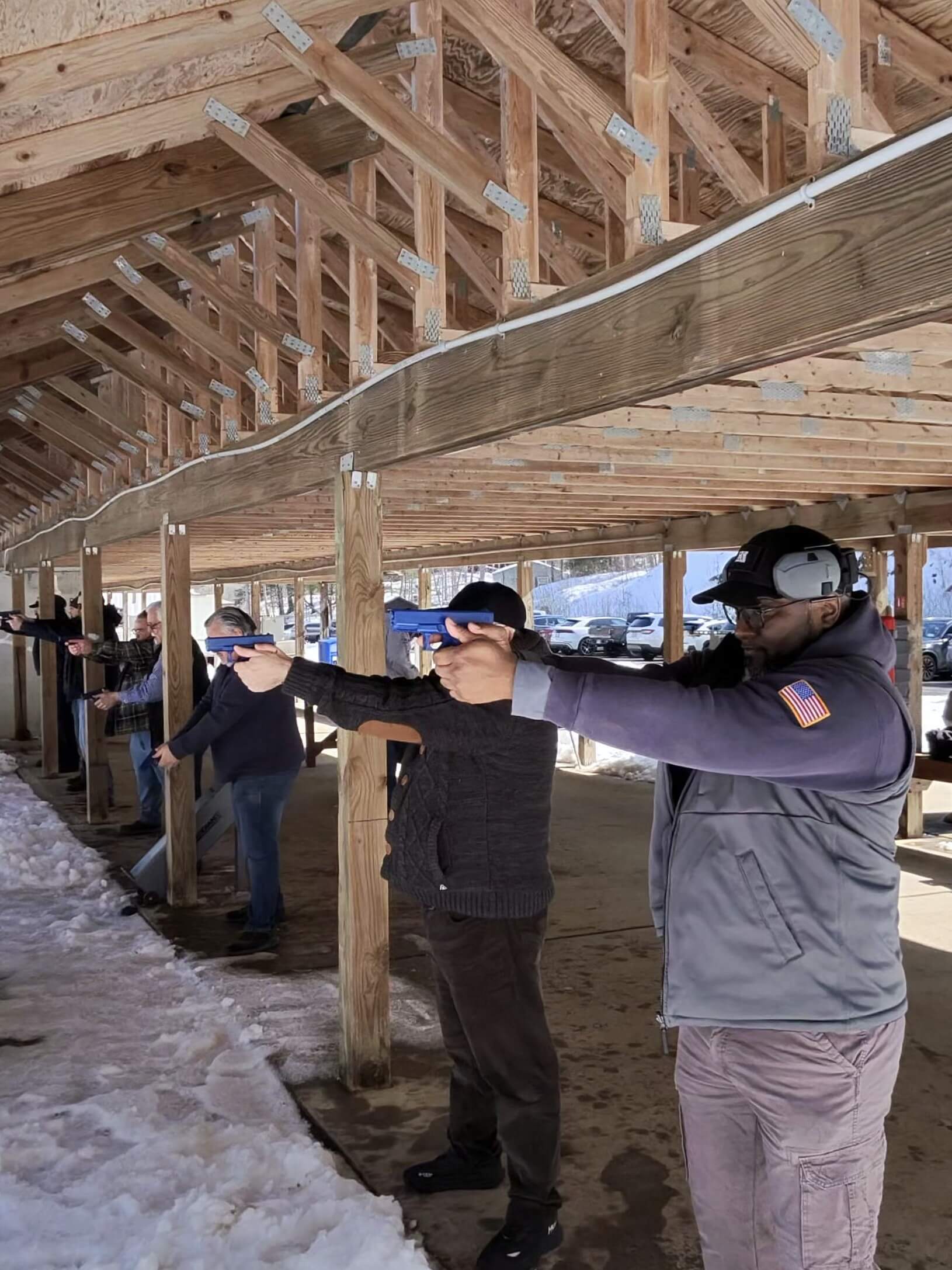 People practicing shooting at outdoor firing range.